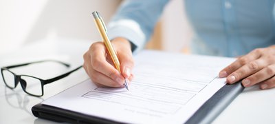 closeup-of-business-woman-making-notes-in-document.jpg